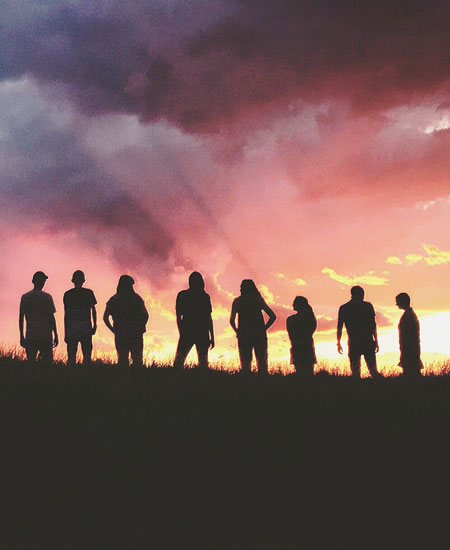 sunrise on mountain top with students